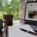 A quiet desk with coffee, notebook, laptop, and the A Voice For Change website open, reflecting information overload and the need for calmer health decisions.