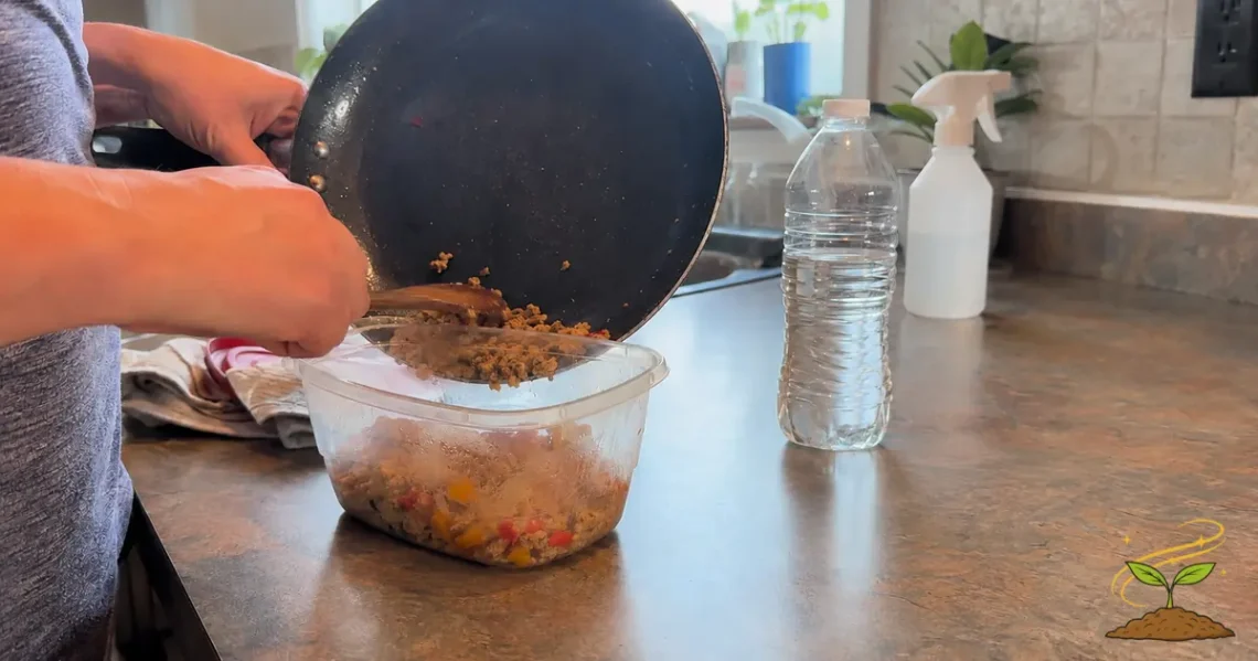 Everyday kitchen scene showing warm food placed in plastic beside a water bottle and household spray, representing endocrine disruptor exposure.