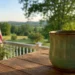 A quiet porch scene with a coffee mug on a wooden table, an American flag in the background, and open countryside beyond, representing the courage to live differently with calm conviction.